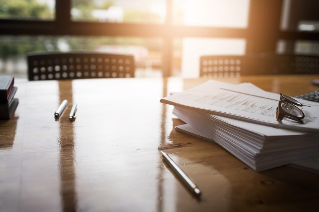 Office desk with papers and pens