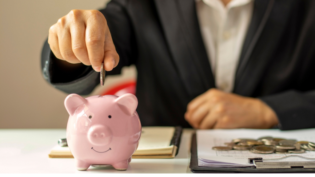 Man dropping coin in piggy bank