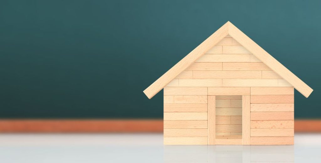 Small wooden house on white table