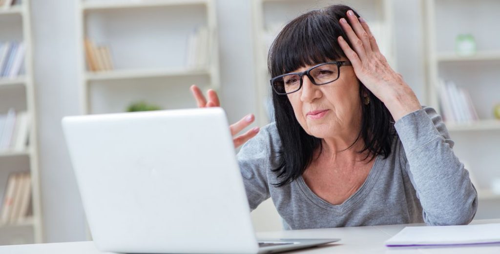 Confused woman using laptop