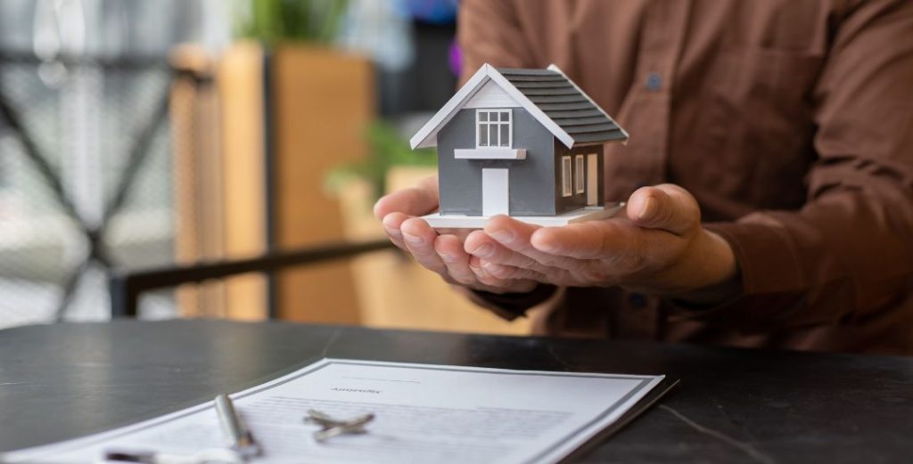 Small Toy House in a Man's Hands