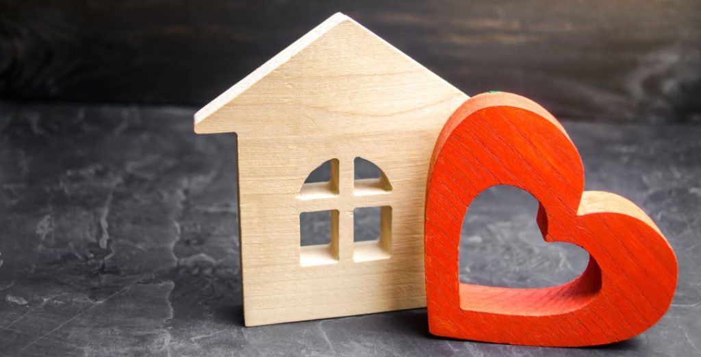 Small Wooden House With Wooden Heart Nearby