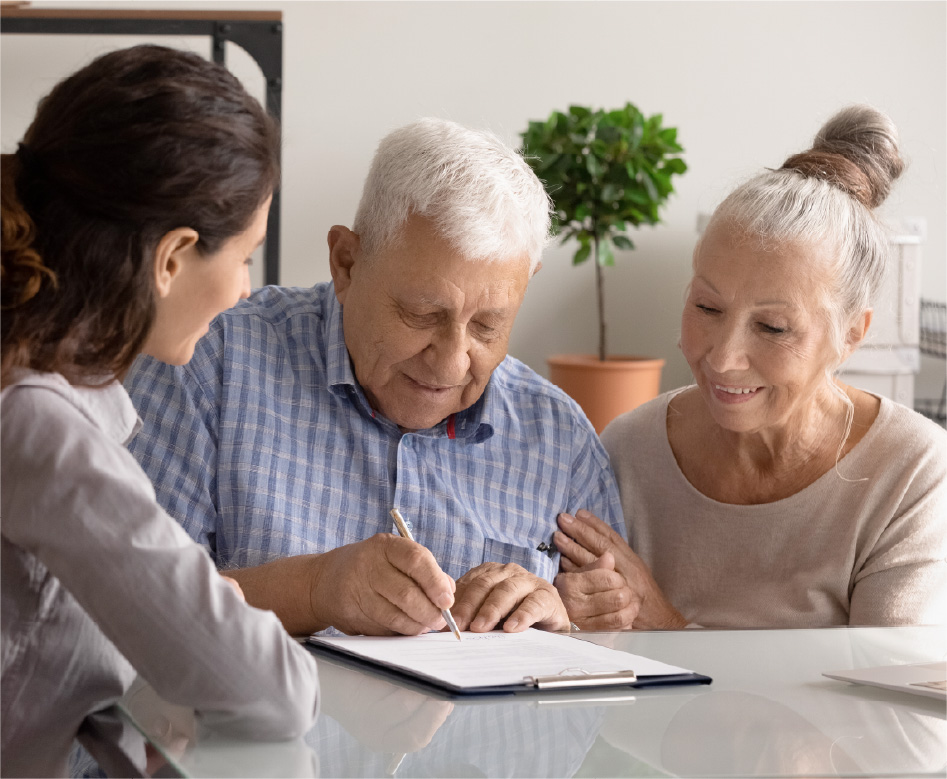 Elderly couple signing document