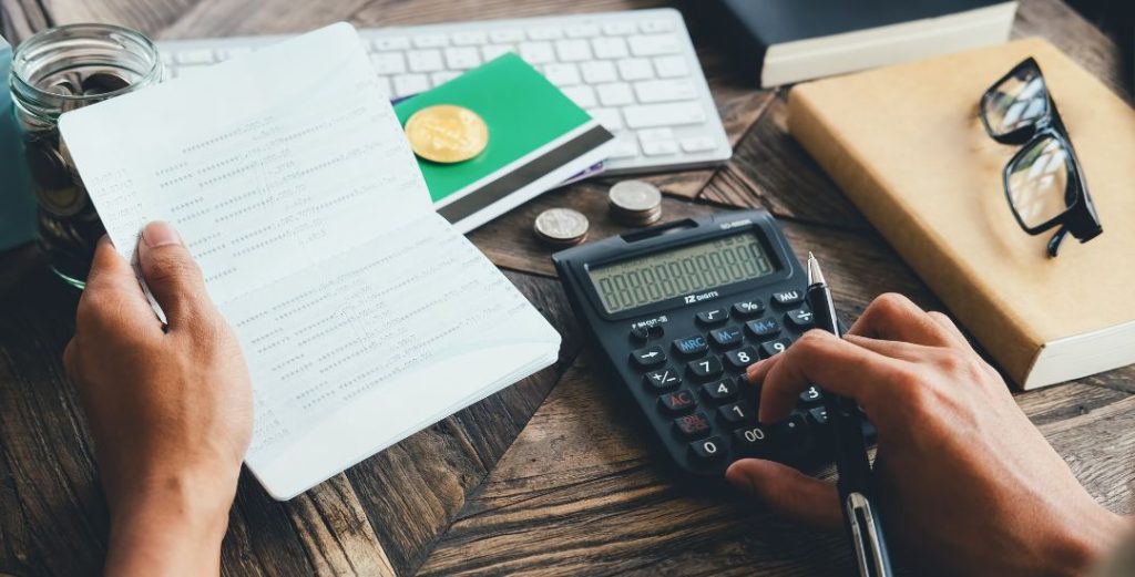 Calculator and Financial Book on Desk