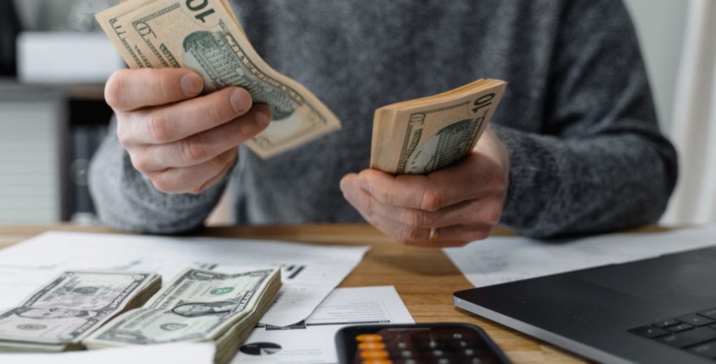 Man Counting Money Doing His Finances