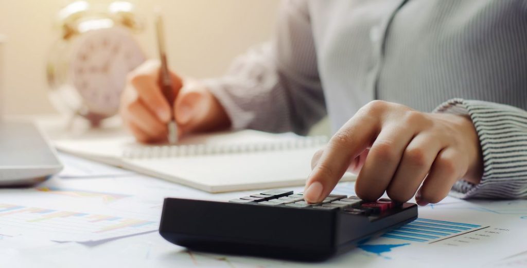 Person using calculator at desk